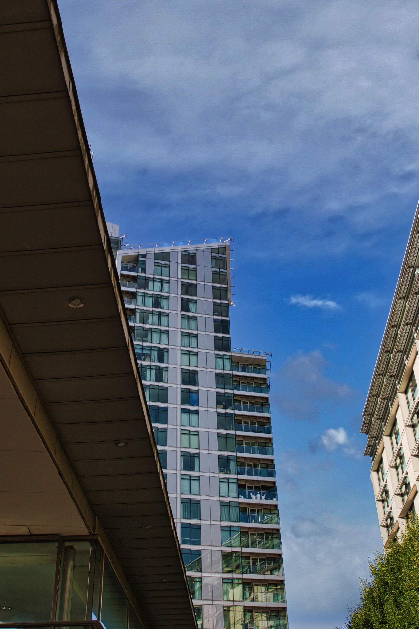 Modern Building Partially Obscured by Angular Structure in Manchester, UK.